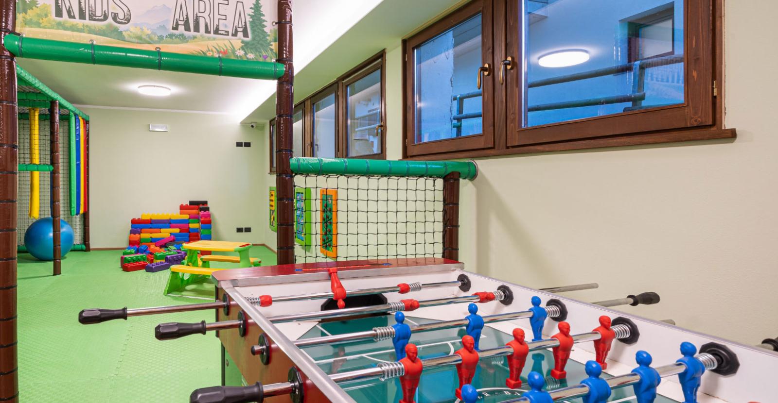 Kids play area with foosball table and colorful building blocks.