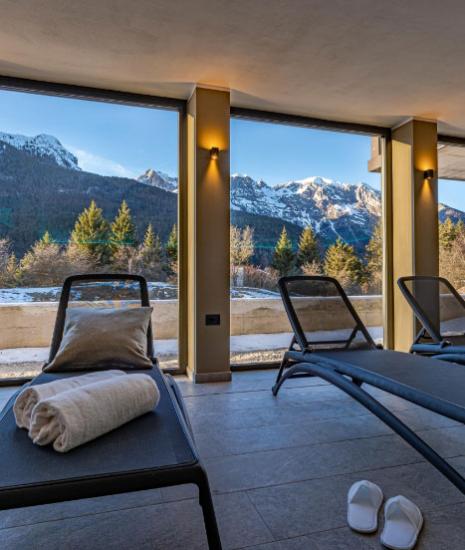 Lounge chairs with a snowy mountain view, perfect for relaxation.