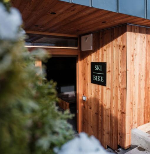 Entrance to a wooden ski and bike storage.