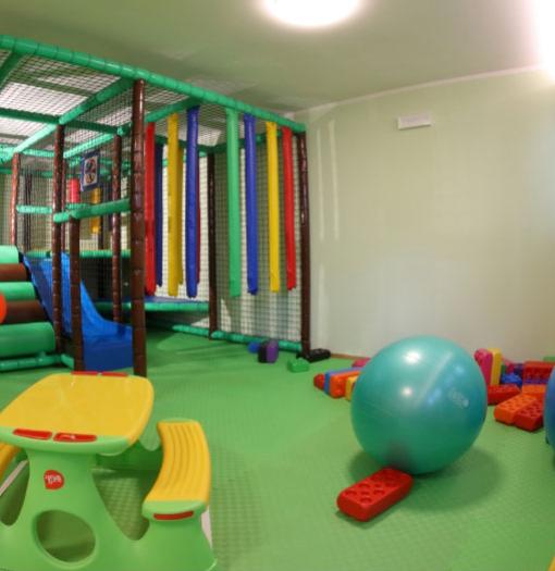 Children's play area with balls, slide, and colorful building blocks.